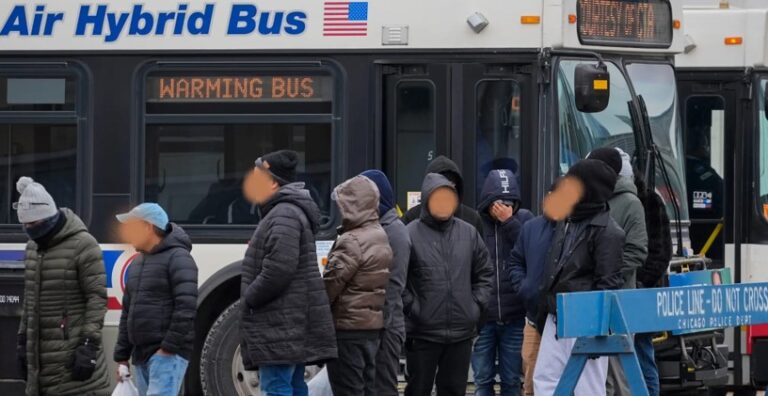 Immigrants lined up to board Chicago CTA Warming Bus.